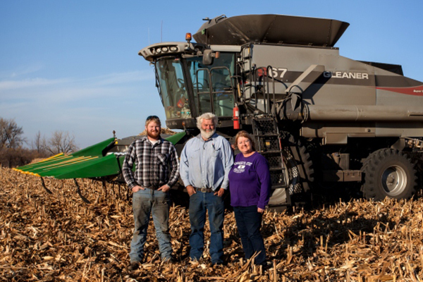 Johnson Family in front of Combine